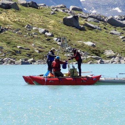 A team on a boat coring lakes in the Arctic (credit: Laura Larocca)